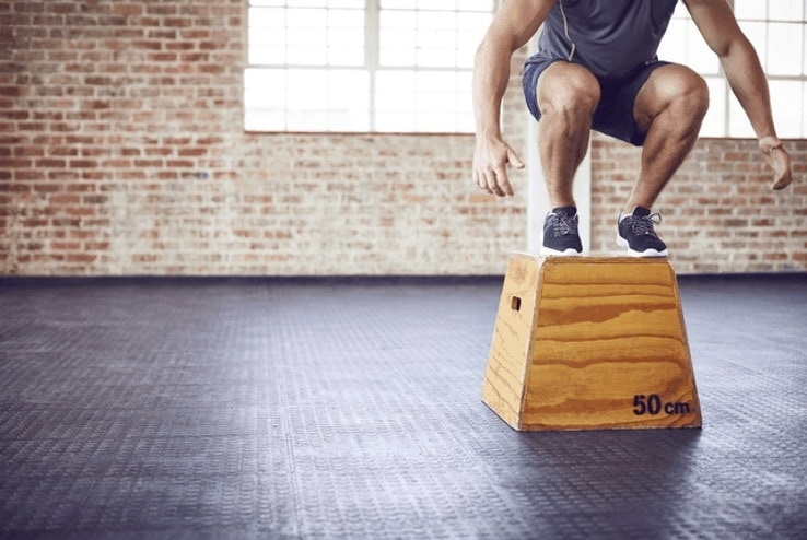 A man doing plyometric exercises in the gym