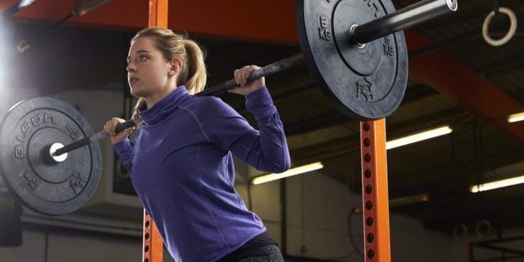 A woman in the gym doing squat exercises